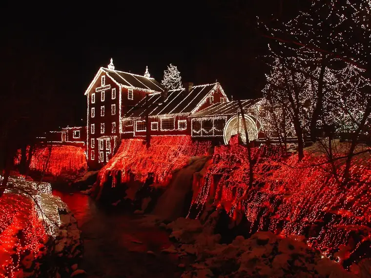 A house glowing with red holiday lights at night